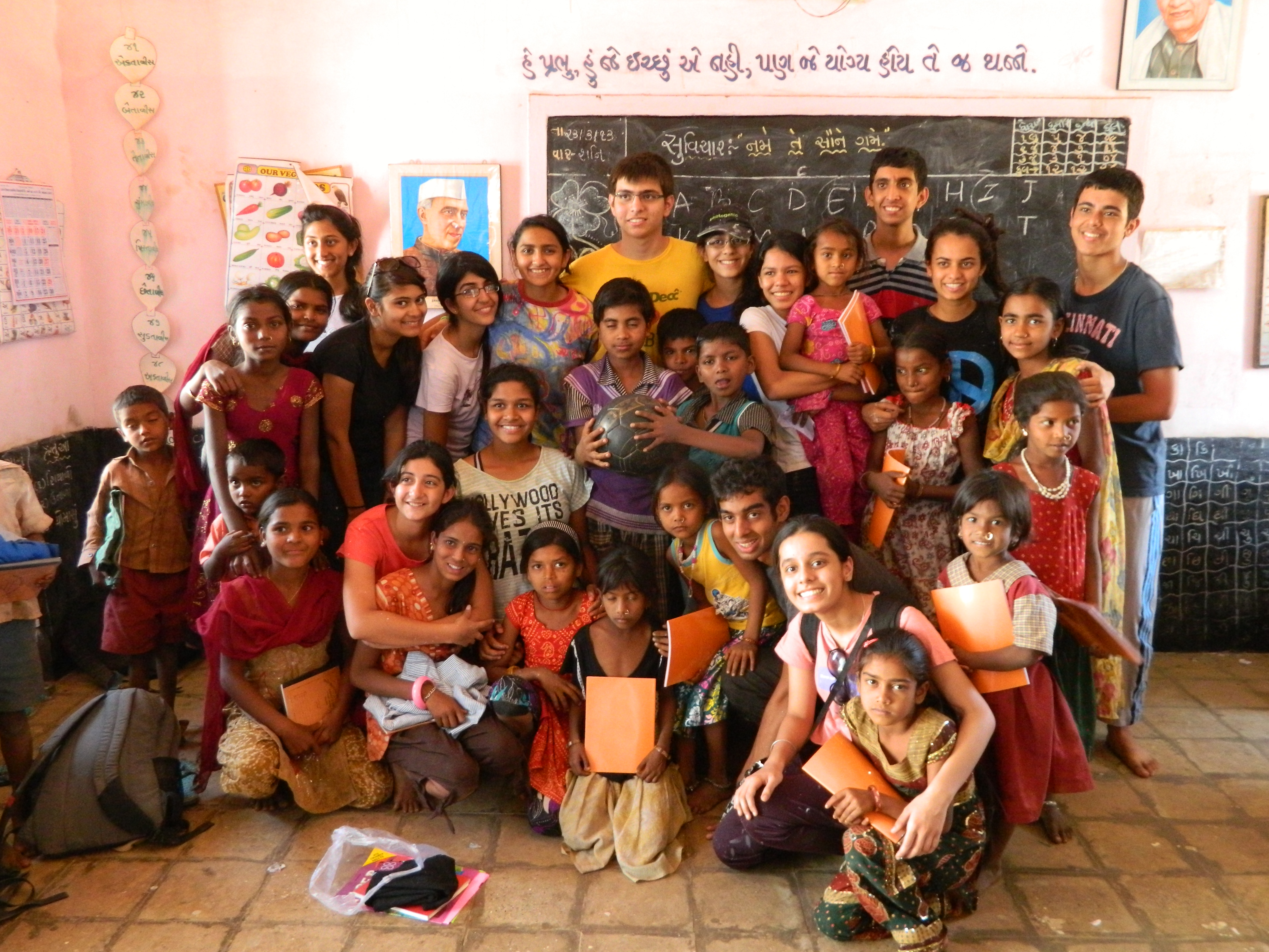 Students and village children together in a classroom