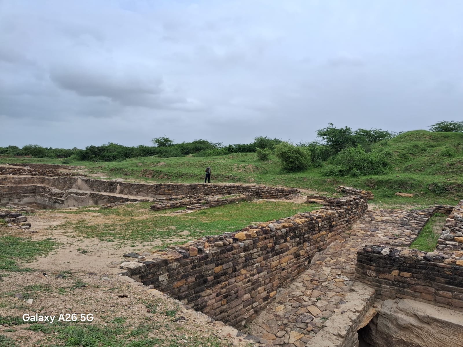 Excavated stone walls of an ancient settlement on a History & Archaeology trip