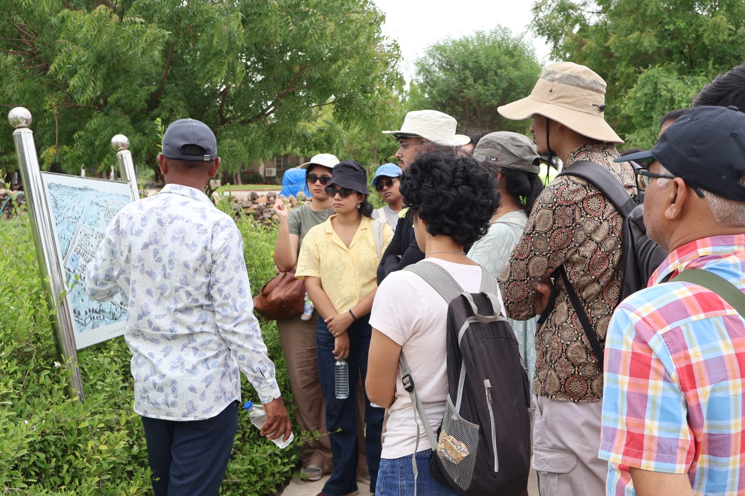A guide explaining a site map to students on a History & Archaeology trip
