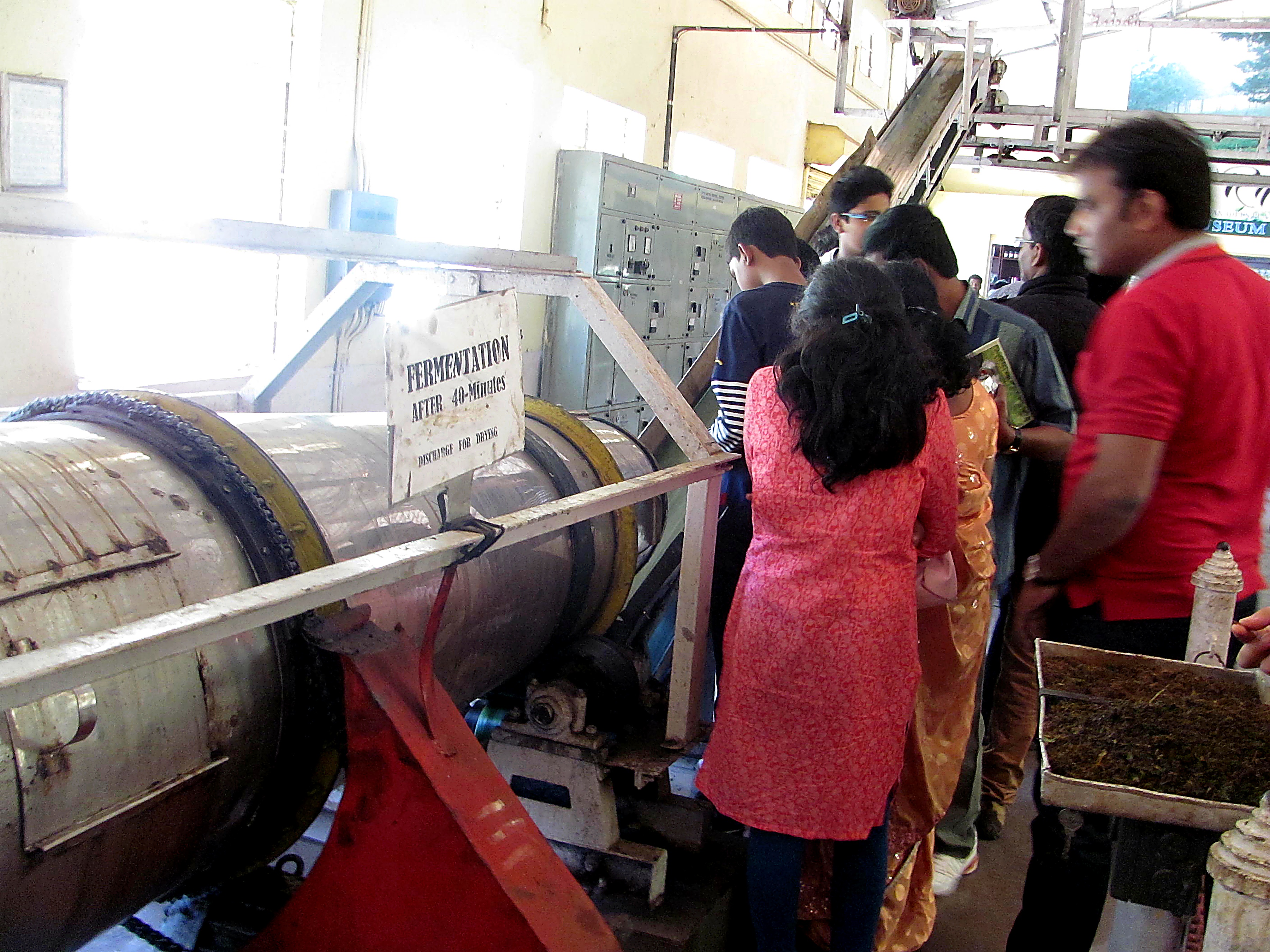 Students at a fermentation machine during a factory tour