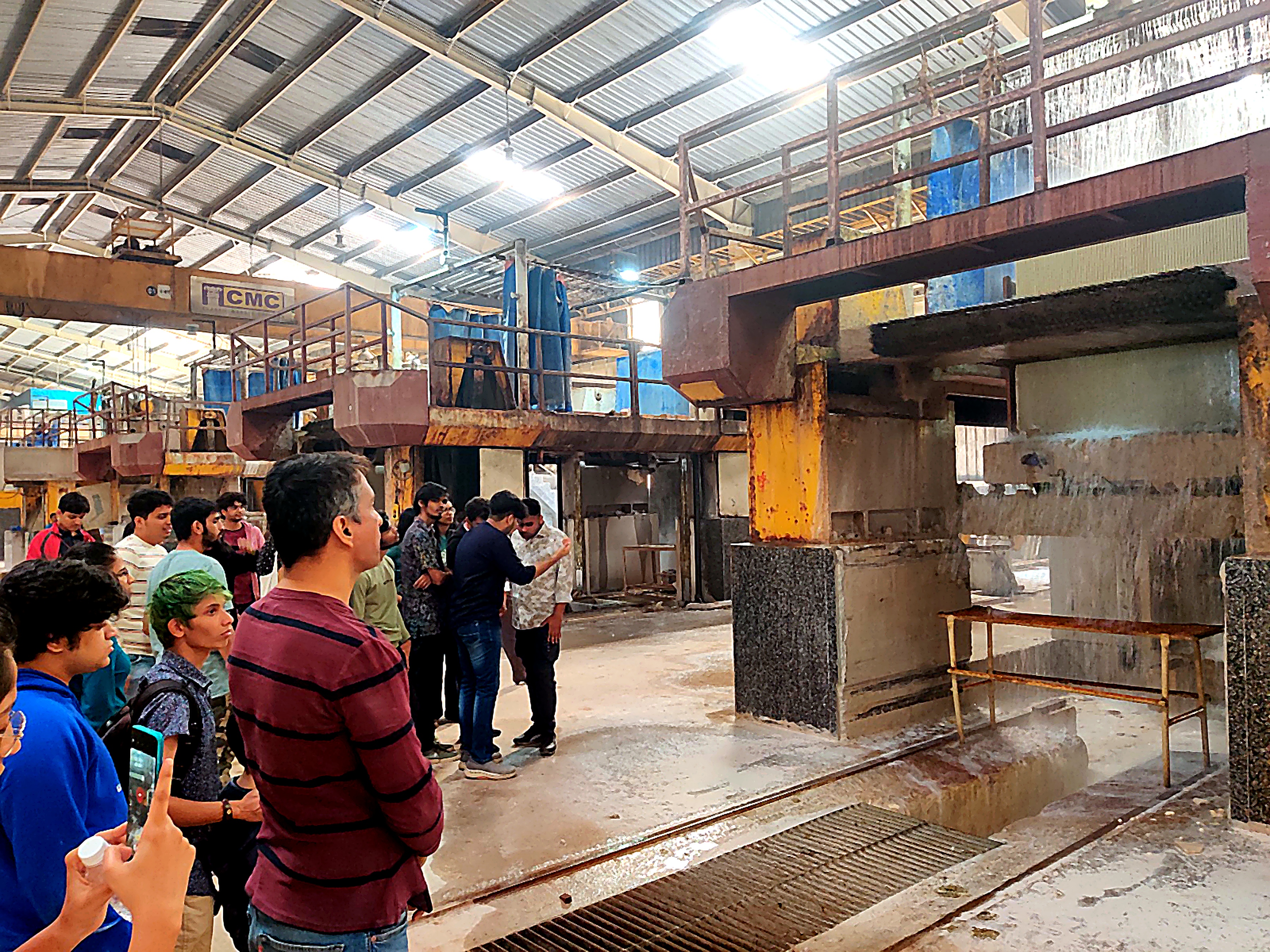 Students touring a manufacturing unit on an industry trip