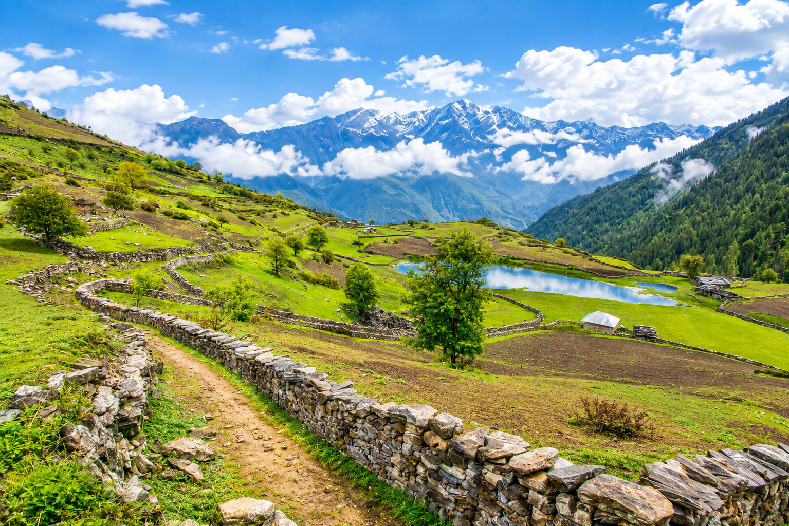 A Himalayan valley trail beside a mountain lake