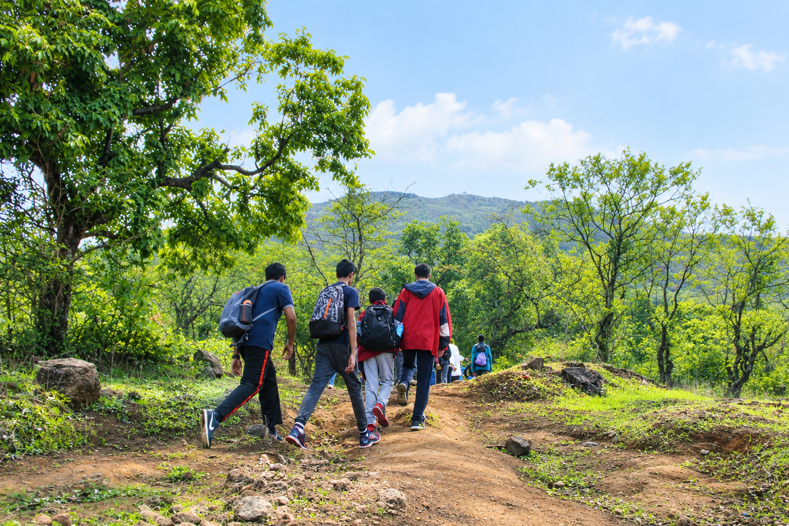 Students hiking a hill trail on an outbound camp