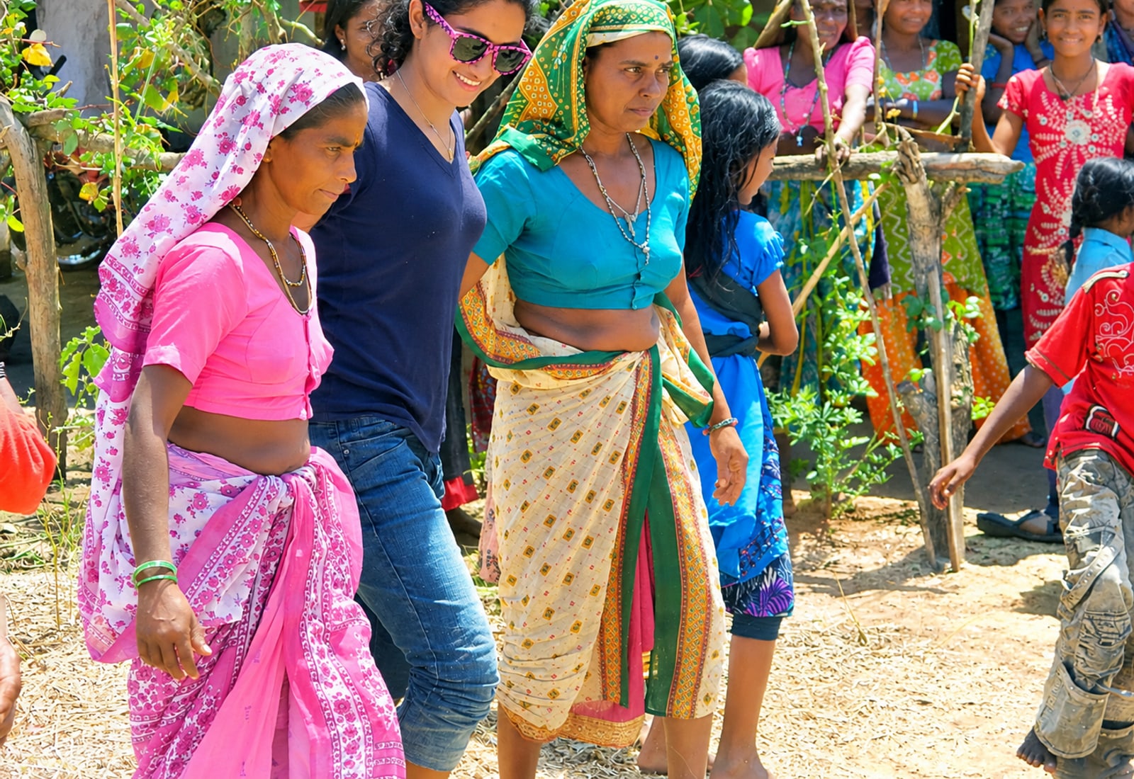 A student walking with women in a village lane